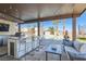 Outdoor kitchen and seating with pool views, bar, a ceiling, and lounge area for entertaining at 720 Camino La Paz, Henderson, NV 89012