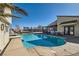 Resort-style backyard featuring a large swimming pool, slide, trampoline, and patio with outdoor dining area at 720 Camino La Paz, Henderson, NV 89012