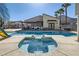 A refreshing pool and spa with lush palm trees offers a relaxing backyard oasis, perfect for entertainment and leisure at 720 Camino La Paz, Henderson, NV 89012