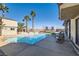 Spacious backyard with a large pool, waterslide, trampoline, and outdoor seating, perfect for Gathering fun and entertaining at 720 Camino La Paz, Henderson, NV 89012