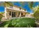 Spacious backyard featuring artificial turf, covered patio, and landscaped border, perfect for outdoor entertaining at 7427 Tomahawk Bend Ave, Las Vegas, NV 89113