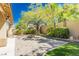 Backyard space boasting mature trees, a fire pit, lush landscaping, and a cozy ambiance at 7427 Tomahawk Bend Ave, Las Vegas, NV 89113
