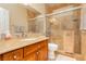 Bathroom featuring a marble vanity with a sink and a glass-enclosed shower with tiled walls at 7427 Tomahawk Bend Ave, Las Vegas, NV 89113