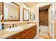 Well-lit bathroom with double sinks, granite countertops, and traditional wood cabinetry at 7427 Tomahawk Bend Ave, Las Vegas, NV 89113