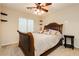 Bedroom featuring a decorative ceiling fan, a comfortable queen bed and bedside table at 7427 Tomahawk Bend Ave, Las Vegas, NV 89113