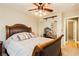 Bedroom features decorative ceiling fan, comfortable queen bed and mirrored closet door at 7427 Tomahawk Bend Ave, Las Vegas, NV 89113
