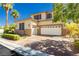 Charming two-story home with a three car garage surrounded by green landscape at 7427 Tomahawk Bend Ave, Las Vegas, NV 89113