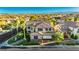 Expansive two-story home with desert landscaping, mountain views, and tile roof in quiet neighborhood at 7427 Tomahawk Bend Ave, Las Vegas, NV 89113