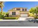 Charming two-story home with a two car garage surrounded by green landscape at 7427 Tomahawk Bend Ave, Las Vegas, NV 89113