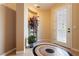 Bright foyer featuring custom tile mosaic, high ceilings, and an inviting glass front door at 7427 Tomahawk Bend Ave, Las Vegas, NV 89113