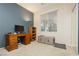 Home office featuring a wooden desk, shelving, and ample natural light from the window at 7427 Tomahawk Bend Ave, Las Vegas, NV 89113
