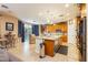 Bright kitchen featuring stainless steel appliances, center island, travertine floors and light wood cabinetry at 7427 Tomahawk Bend Ave, Las Vegas, NV 89113
