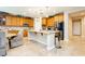 Spacious eat-in kitchen featuring stainless appliances, center island and travertine floors at 7427 Tomahawk Bend Ave, Las Vegas, NV 89113