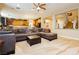 Living room with fireplace, built-in bookcase and connecting kitchen at 7427 Tomahawk Bend Ave, Las Vegas, NV 89113
