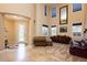 Spacious living room with travertine floors, designer paint, and a cozy seating area at 7427 Tomahawk Bend Ave, Las Vegas, NV 89113