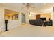 Spacious living room with plush leather seating, carpet flooring, and a ceiling fan at 7427 Tomahawk Bend Ave, Las Vegas, NV 89113