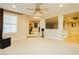 Expansive living room with a ceiling fan, carpet flooring, and an open layout at 7427 Tomahawk Bend Ave, Las Vegas, NV 89113