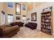 Spacious living room with travertine floors, designer paint, and a cozy seating area with natural light at 7427 Tomahawk Bend Ave, Las Vegas, NV 89113