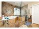 Luxurious main bathroom featuring stone tile, glass shower and separate tub at 7427 Tomahawk Bend Ave, Las Vegas, NV 89113