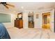 Bright main bedroom featuring neutral walls, carpet flooring, and a view into the main bathroom at 7427 Tomahawk Bend Ave, Las Vegas, NV 89113