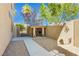 A practical side yard features a shaded storage area and pathway, offering both utility and curb appeal at 7427 Tomahawk Bend Ave, Las Vegas, NV 89113