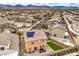 Extensive aerial view showcases a neighborhood with modern homes and beautiful mountain views beyond at 7948 Eastern Elk St, Las Vegas, NV 89149