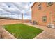 Backyard with a small patch of synthetic grass and gravel, designed for easy maintenance at 7948 Eastern Elk St, Las Vegas, NV 89149