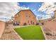 Spacious backyard with artificial turf, a gravel area, and a hot tub at 7948 Eastern Elk St, Las Vegas, NV 89149
