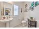 Powder room with a pedestal sink, modern fixtures, and decorative wall art at 7948 Eastern Elk St, Las Vegas, NV 89149