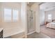 Bathroom with a glass enclosed shower, garden tub, plantation shutters and adjacent bedroom at 7948 Eastern Elk St, Las Vegas, NV 89149