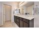 Bathroom featuring a double vanity with stone countertops and dark wood cabinetry at 7948 Eastern Elk St, Las Vegas, NV 89149