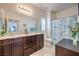 Bathroom featuring a double vanity with stone countertops and a shower behind a floral shower curtain at 7948 Eastern Elk St, Las Vegas, NV 89149