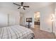 Bedroom with access to a bathroom, ceiling fan and a modern television stand at 7948 Eastern Elk St, Las Vegas, NV 89149
