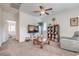 Cozy bedroom featuring a ceiling fan, comfortable armchair, and built-in shelving at 7948 Eastern Elk St, Las Vegas, NV 89149