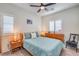 Bedroom featuring windows, a ceiling fan, and light wood bedroom furniture at 7948 Eastern Elk St, Las Vegas, NV 89149