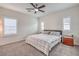 Spacious bedroom with a ceiling fan, neutral carpet, two windows and a bed with matching nightstands at 7948 Eastern Elk St, Las Vegas, NV 89149