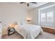 Cozy bedroom features a queen-sized bed, ceiling fan, and window with shutters for natural light at 7948 Eastern Elk St, Las Vegas, NV 89149