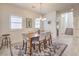 Bright dining room with a wood table, modern chandelier, and stylish area rug at 7948 Eastern Elk St, Las Vegas, NV 89149