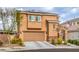 Two-story home with a two-car garage, stone accents and well-maintained landscaping at 7948 Eastern Elk St, Las Vegas, NV 89149