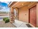 Welcoming front porch with stone pillars, a stylish door, and neatly trimmed bushes at 7948 Eastern Elk St, Las Vegas, NV 89149
