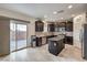 Dark wood cabinets, granite counters and stainless appliances in this modern kitchen at 7948 Eastern Elk St, Las Vegas, NV 89149
