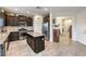 Modern kitchen featuring stainless steel appliances, dark wood cabinets, and a center island at 7948 Eastern Elk St, Las Vegas, NV 89149