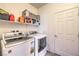 Functional laundry room with washer, dryer, storage shelves, and a door for added convenience at 7948 Eastern Elk St, Las Vegas, NV 89149