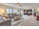 Open floor plan living area featuring tile floors, living room furniture and a modern kitchen at 7948 Eastern Elk St, Las Vegas, NV 89149