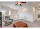 Bright loft space with a chair, table, ceiling fan, and view to the hallway at 7948 Eastern Elk St, Las Vegas, NV 89149