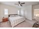 Bedroom with carpeted floors, ceiling fan, and a comfortable plaid-covered bed at 7948 Eastern Elk St, Las Vegas, NV 89149