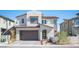 Inviting two-story home with a modern design, a two-car garage, and desert landscaping at 828 Parker Mesa St, Las Vegas, NV 89138