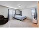 Cozy bedroom featuring a recliner, large window, and neutral carpeting at 829 N Water St, Henderson, NV 89011