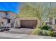 Exterior shot showcasing the two-car garage and landscaped front yard of this lovely home at 829 N Water St, Henderson, NV 89011