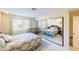 Bright bedroom featuring a full-size bed, tile flooring, and large mirror closet at 929 Sulphur Springs Ln # 102, Las Vegas, NV 89128